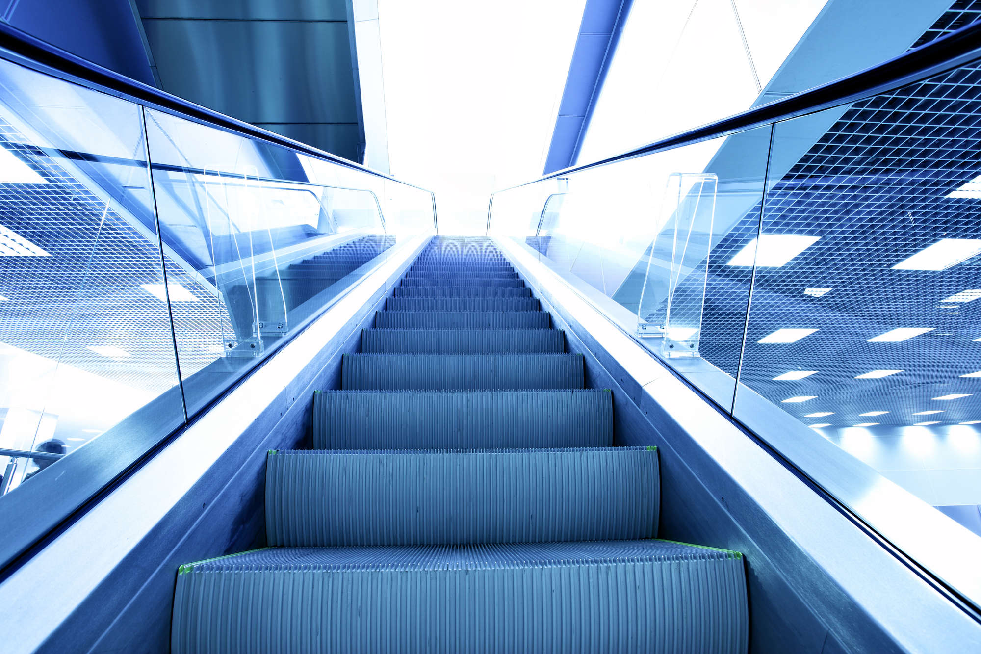 Perspective of escalator toned in blue color