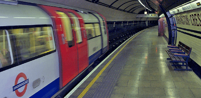 Tube station with passing train